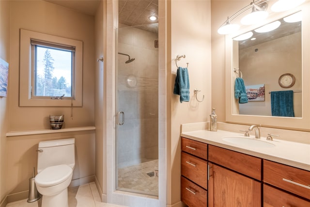 bathroom featuring walk in shower, vanity, toilet, and tile patterned flooring