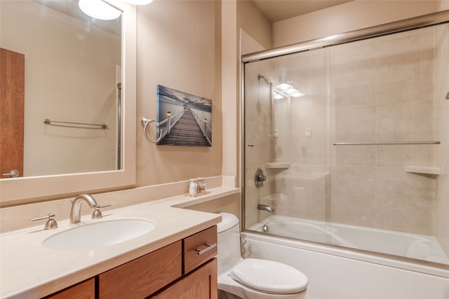 full bathroom with vanity, toilet, and combined bath / shower with glass door