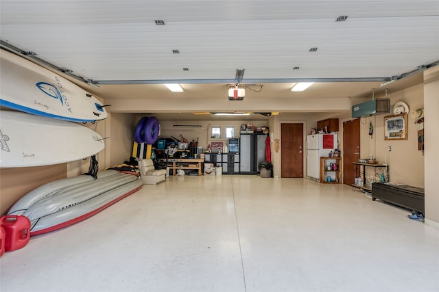 garage featuring a garage door opener and white fridge