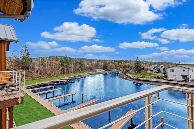 view of swimming pool featuring a water view and a boat dock