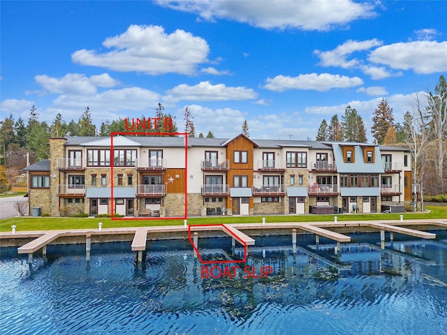 rear view of property featuring a water view