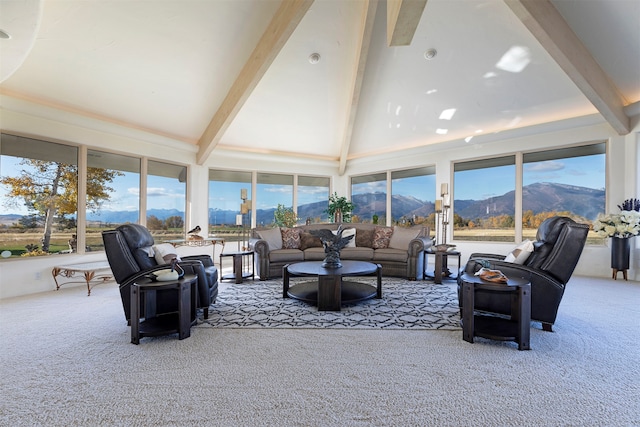 carpeted living room featuring beamed ceiling, a mountain view, and high vaulted ceiling