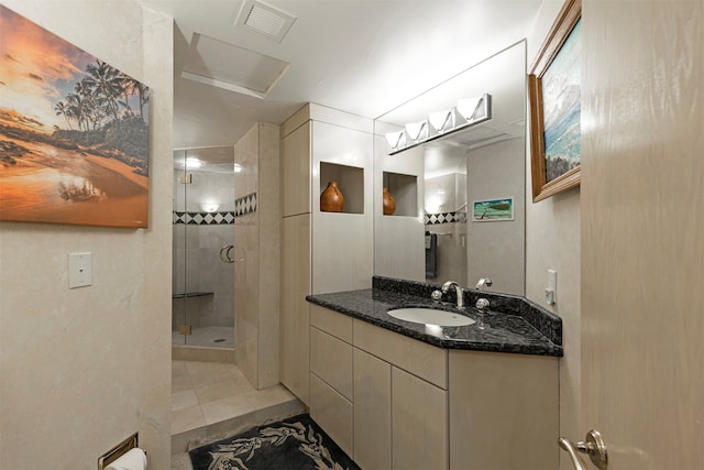 bathroom featuring vanity, walk in shower, and tile patterned flooring