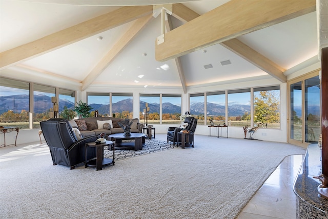 living room with a mountain view, high vaulted ceiling, beam ceiling, and a wealth of natural light