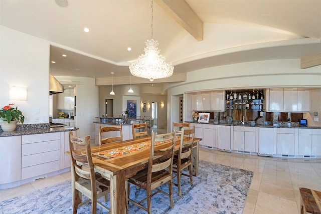 dining area featuring vaulted ceiling with beams and a notable chandelier