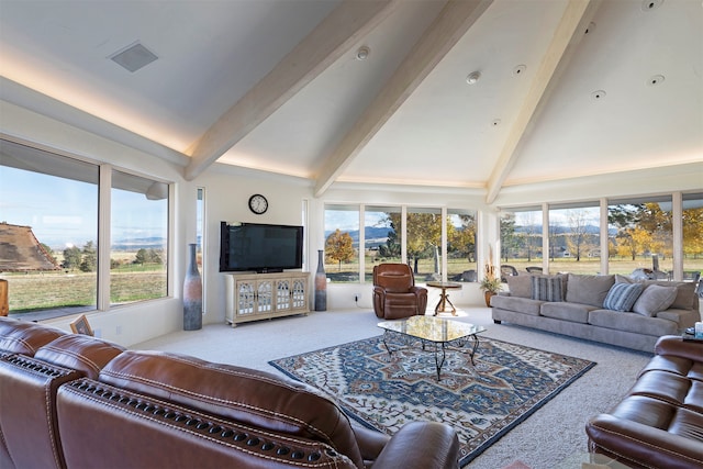 carpeted living room featuring beamed ceiling, high vaulted ceiling, and plenty of natural light