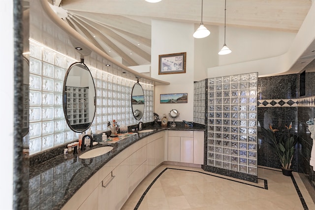 bathroom with vanity, tile patterned floors, and lofted ceiling