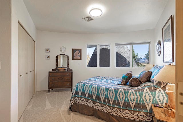 bedroom with a closet and light colored carpet