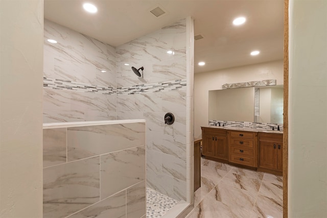 bathroom with vanity and tiled shower