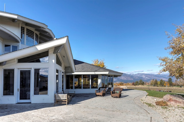 exterior space with a mountain view and a sunroom