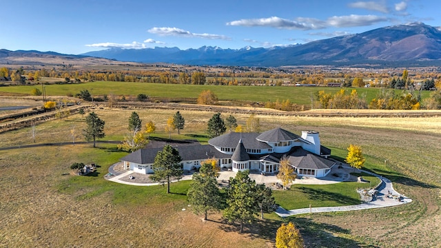 birds eye view of property with a mountain view and a rural view