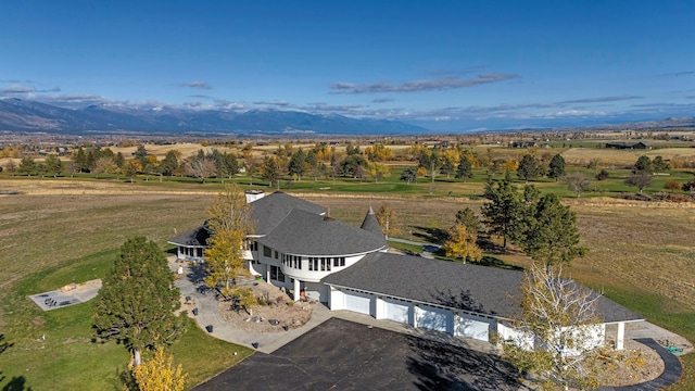 drone / aerial view featuring a mountain view and a rural view