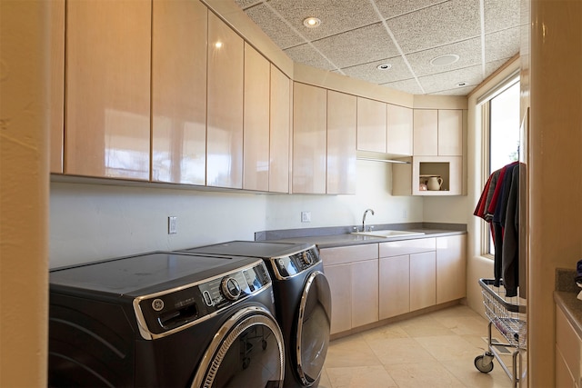 laundry area featuring cabinets, sink, and washing machine and clothes dryer