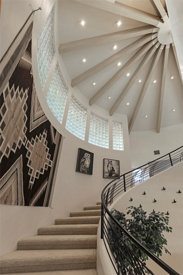 stairs featuring beam ceiling