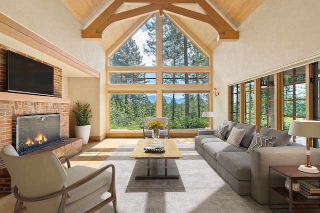 living room with beam ceiling, high vaulted ceiling, and a brick fireplace