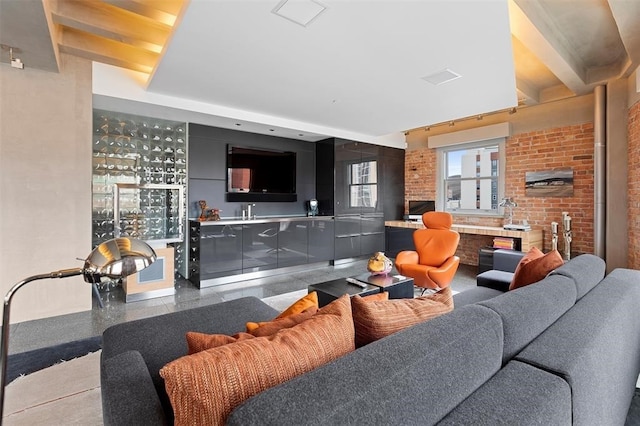 living room featuring brick wall, bar, and light tile floors