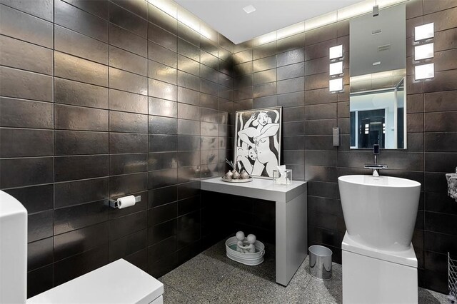 bathroom with backsplash, tile walls, and toilet