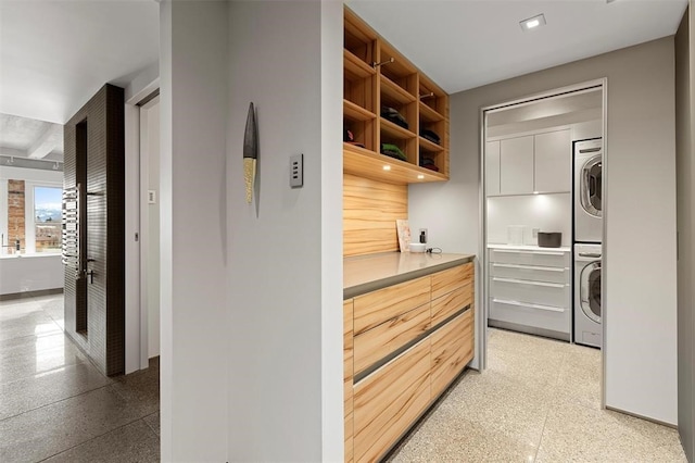 kitchen with stacked washer and dryer