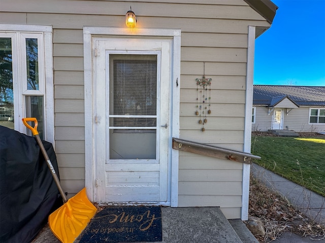 doorway to property featuring a yard