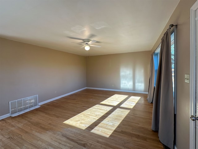 empty room featuring ceiling fan and dark hardwood / wood-style floors