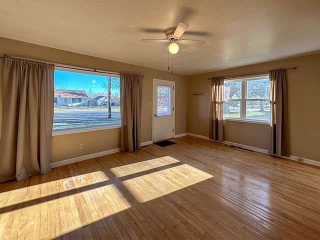 unfurnished room featuring ceiling fan and light wood-type flooring