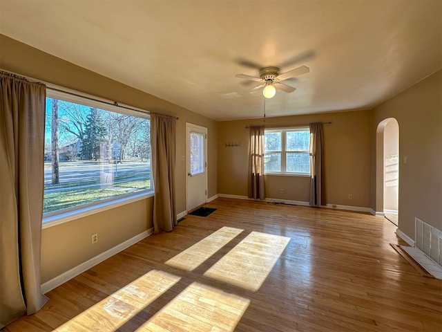 empty room featuring ceiling fan and light hardwood / wood-style flooring