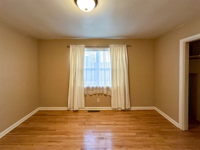 unfurnished room with light hardwood / wood-style flooring