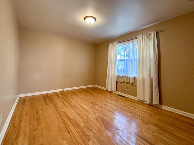 unfurnished room with light hardwood / wood-style floors