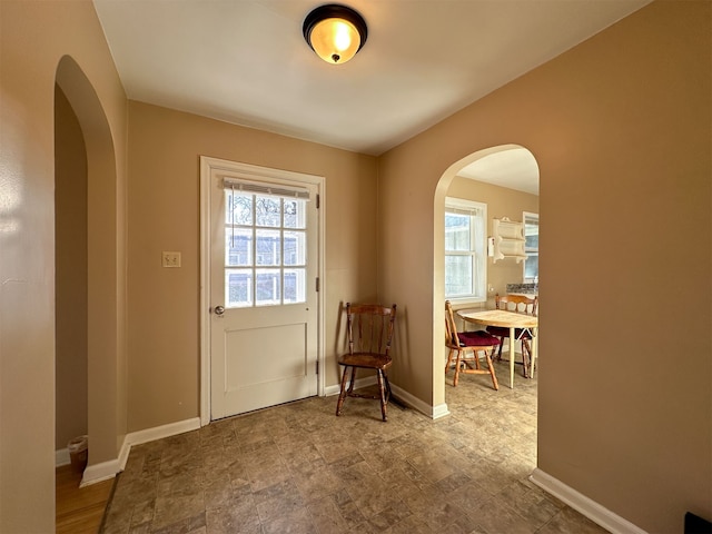 entryway with light tile floors and a healthy amount of sunlight