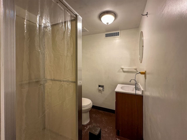 bathroom featuring toilet, vanity, and an enclosed shower