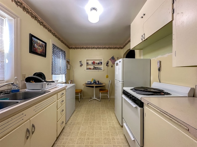 kitchen featuring white cabinets, white range with electric cooktop, sink, and light tile flooring