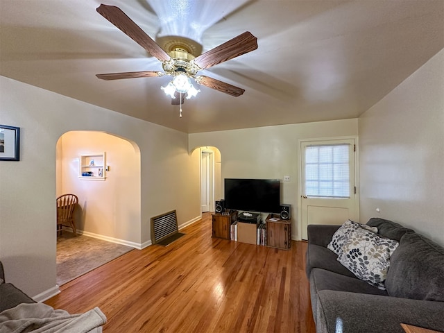 living room featuring ceiling fan and light wood-type flooring