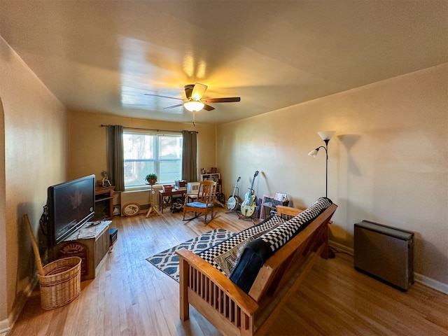 living room featuring ceiling fan and light wood-type flooring