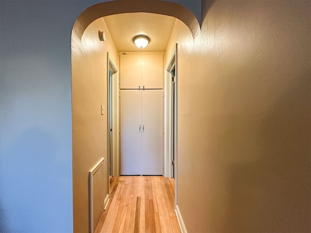 hallway with light hardwood / wood-style flooring