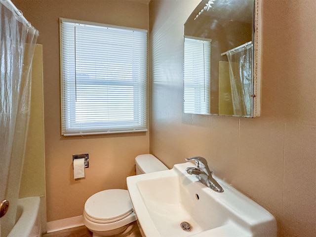 full bathroom with sink, shower / bath combo, and toilet