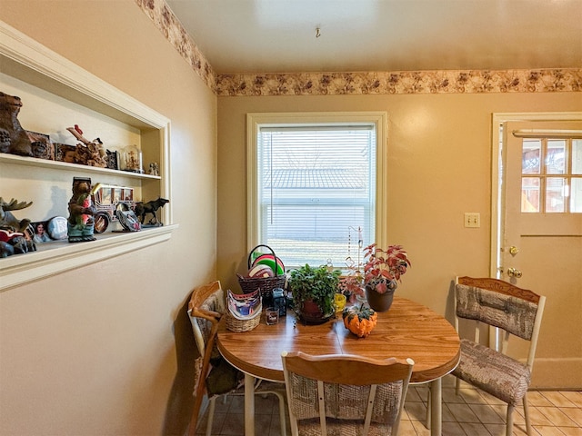 dining space featuring light tile flooring and a healthy amount of sunlight