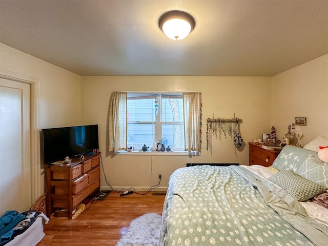 bedroom with wood-type flooring