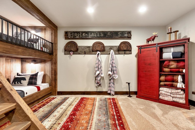 mudroom featuring baseboards and carpet