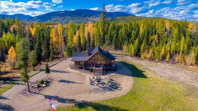 drone / aerial view featuring a mountain view and a wooded view
