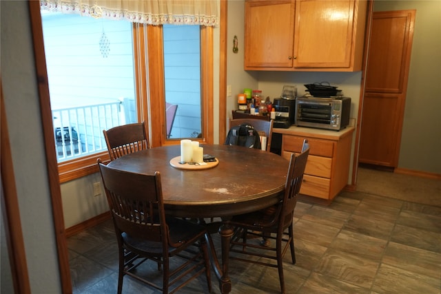 dining space with dark tile flooring