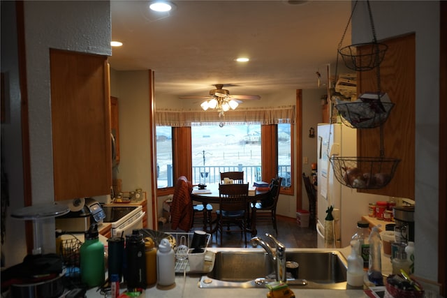 kitchen featuring ceiling fan and sink