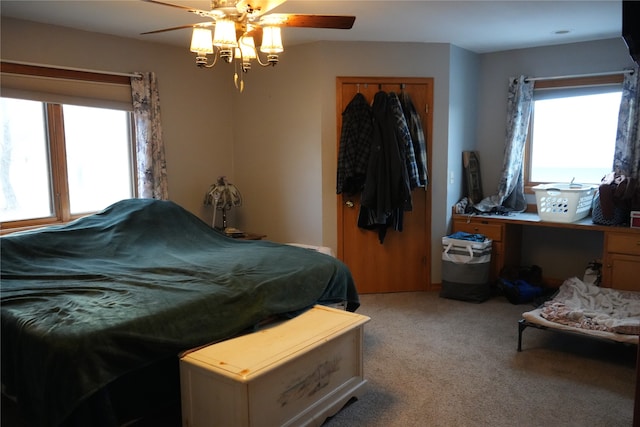 bedroom with ceiling fan and light carpet