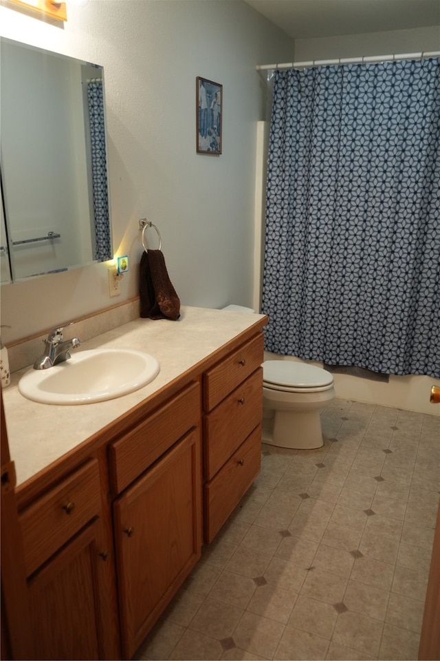 bathroom with toilet, tile flooring, and vanity