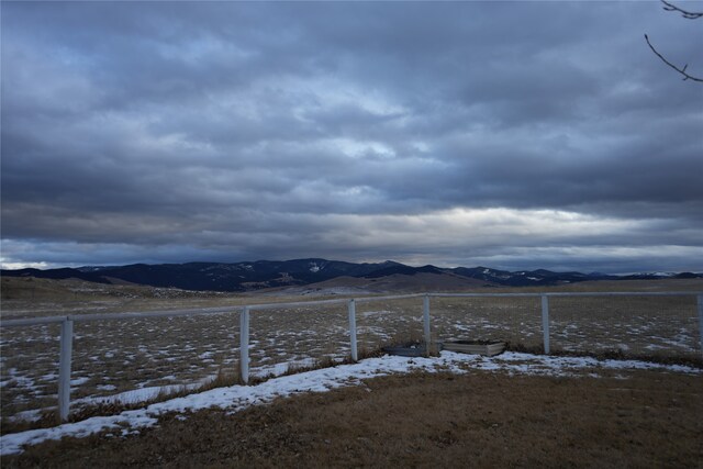 view of yard with a mountain view and a rural view