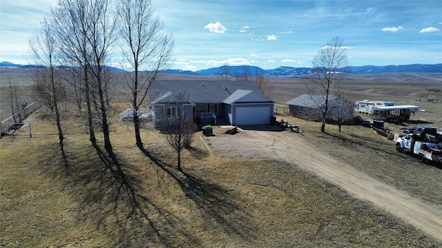 exterior space featuring a mountain view, a rural view, and a garage