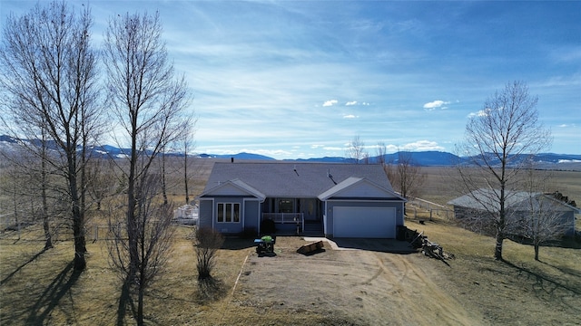 single story home with a mountain view and a garage