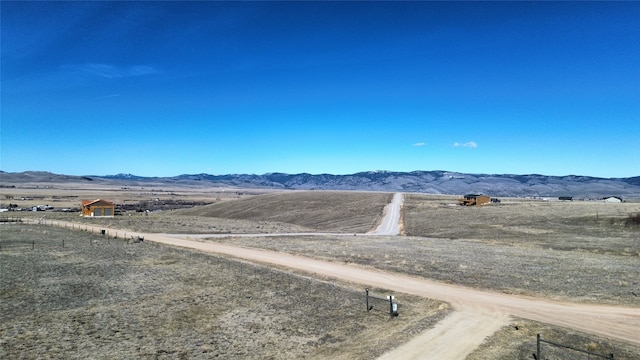 drone / aerial view featuring a rural view and a mountain view