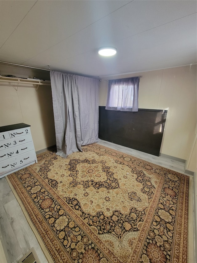 bedroom with hardwood / wood-style flooring and a closet