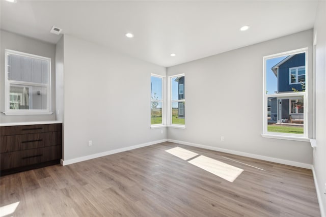 spare room with light wood-type flooring