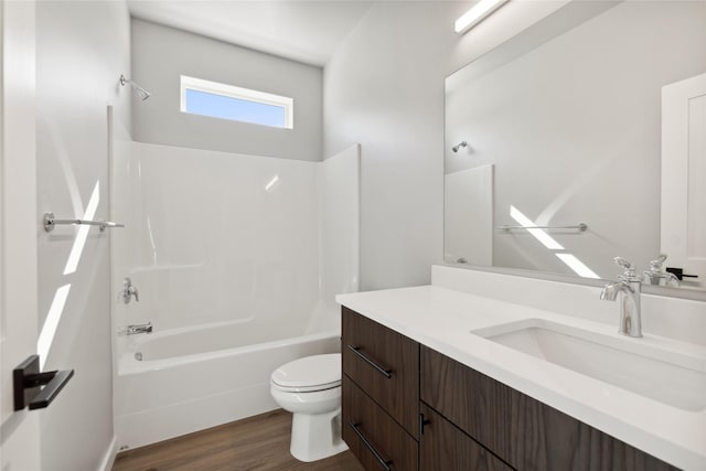 full bathroom with hardwood / wood-style flooring, shower / tub combination, vanity, and toilet